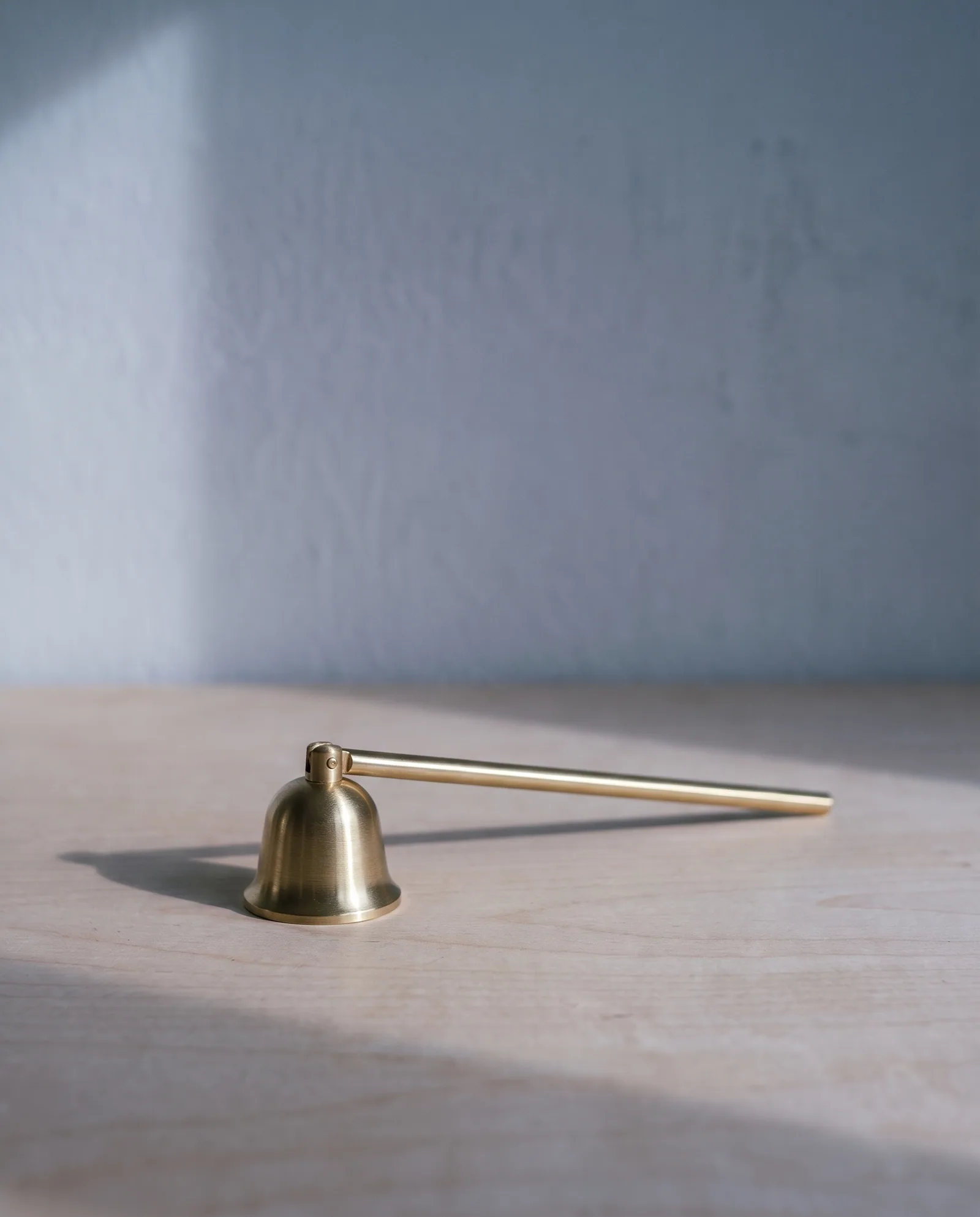 Candle Snuffer — Brushed brass bell · long handle
